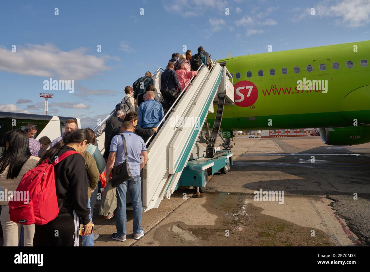 MOSCOW, RUSSIA - CIRCA SEPTEMBER, 2019: people boarding S7 airliner on tarmac at Moscow Domodedovo Airport. Stock Photo