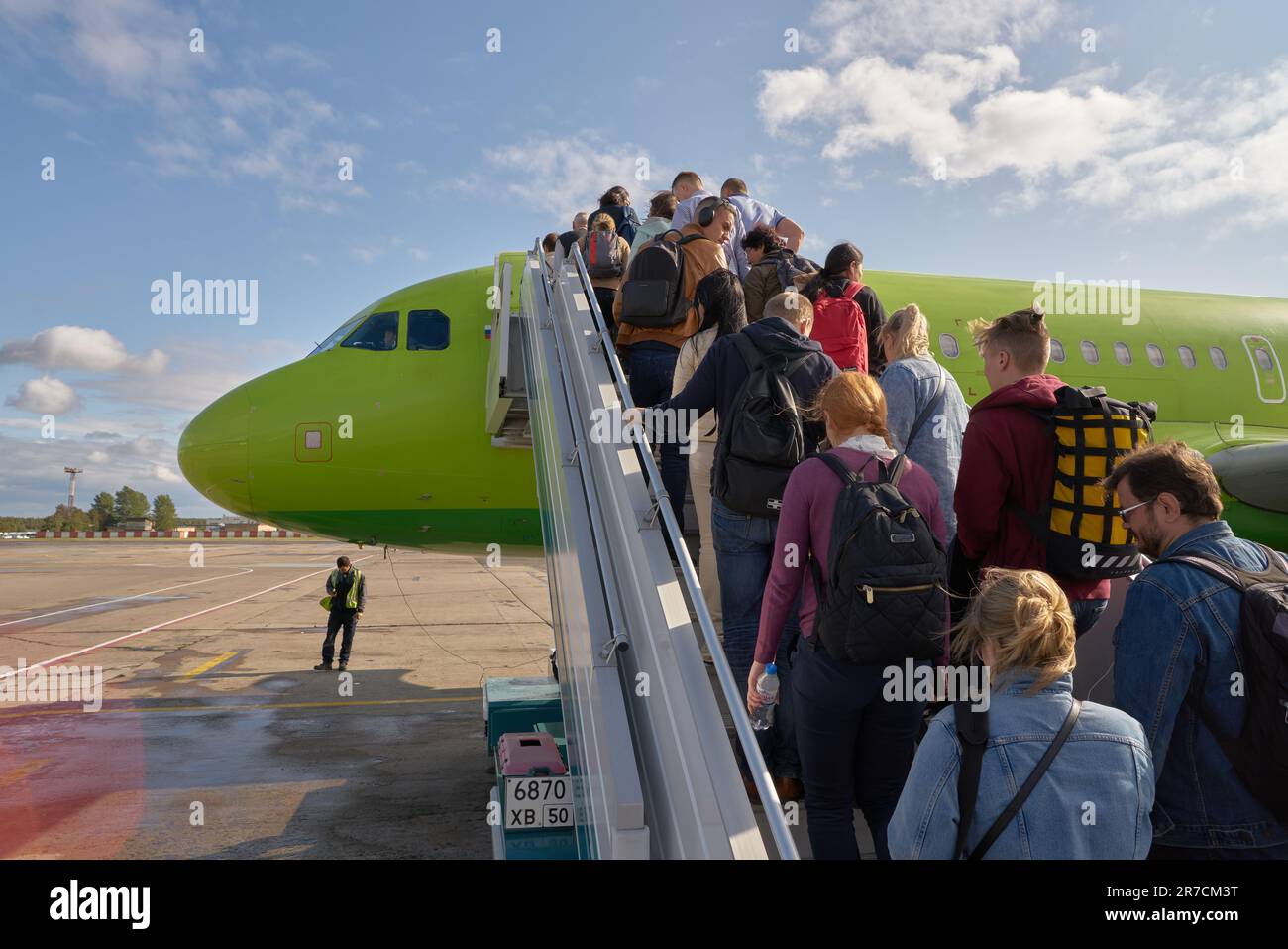 MOSCOW, RUSSIA - CIRCA SEPTEMBER, 2019: people boarding S7 airliner on tarmac at Moscow Domodedovo Airport. Stock Photo