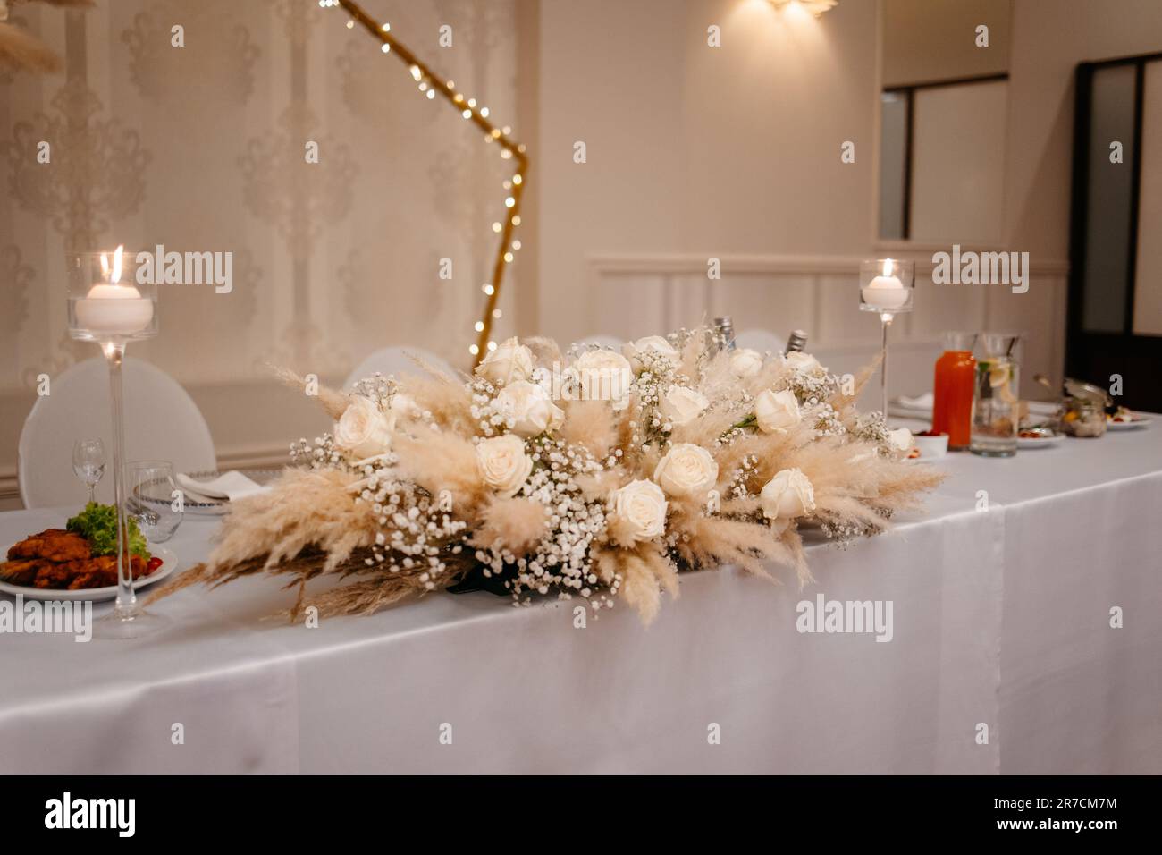 Boho wedding table set. vintage dining table with decorations, flowers and pampas grass Boho