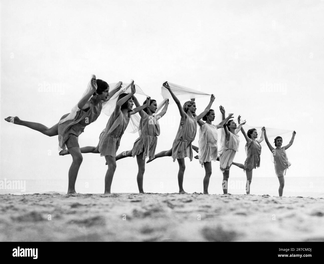 Virginia Beach, Virginia:  c. 1929. Students of the Preston School Dance perform a Grecian Dance at sunrise on the sands of the Cavalier Beach Club. Stock Photo