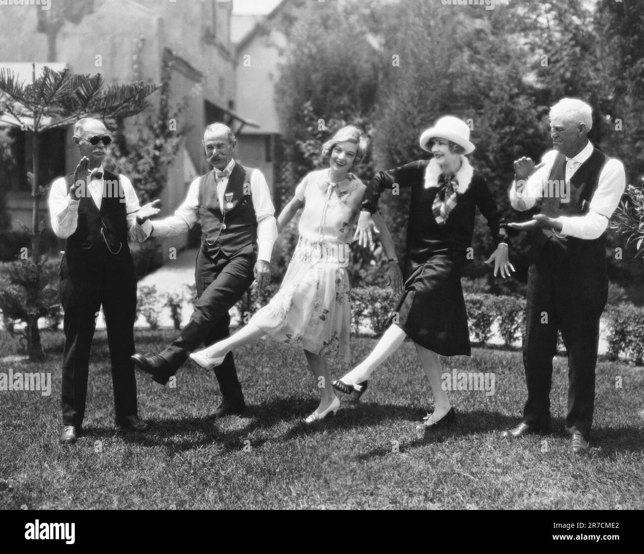 Hollywood, California:   September 3, 1925 Old soldiers from the Home near Hollywood claim that the new Charleston dance originated right after the Civil War, and here they are teaching actresses Dorothy McKaill and Joyce Compton the steps. Stock Photo
