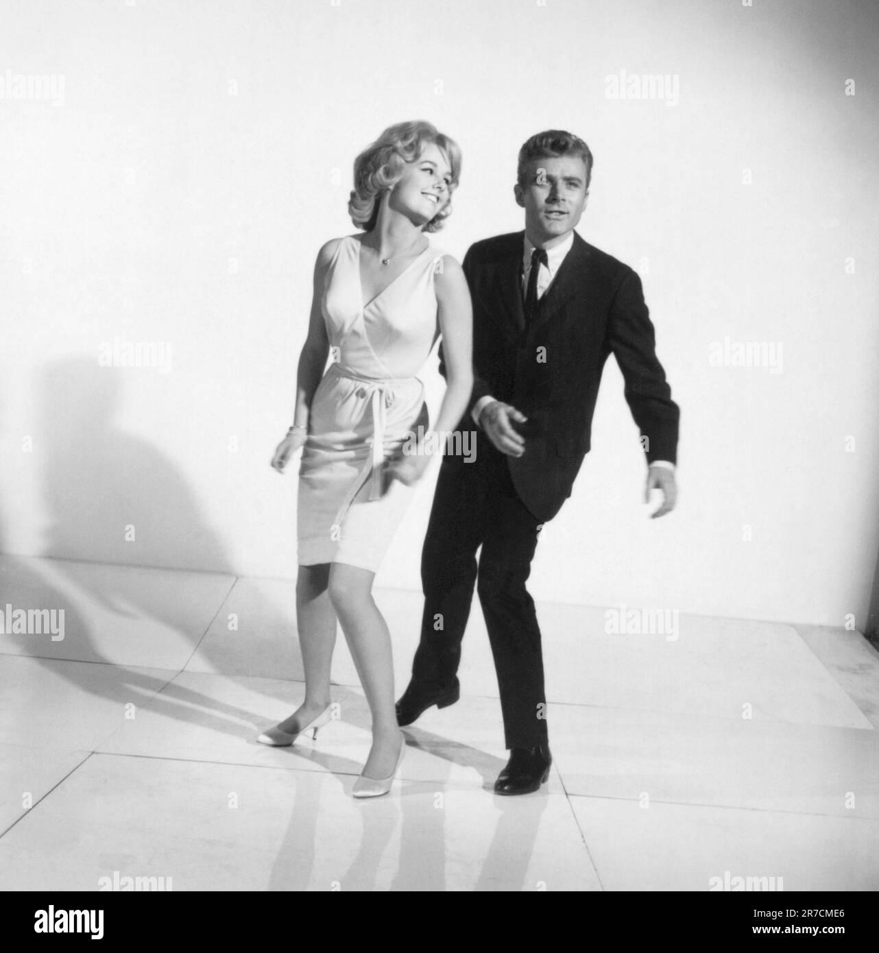 United States:  c. 1961 A photograph of a couple demonstrating how to dance the twist. Stock Photo