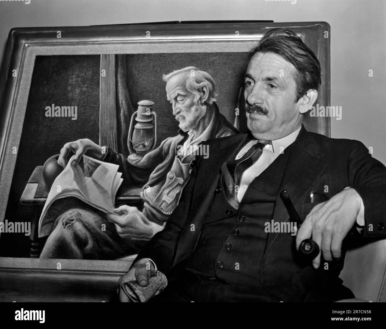 New York, New York,  April 5, 1941 Artist Thomas Hart Benton, seated in front of his painting, 'Old Man Reading', astounded gallery directors today by saying he would rather hang his pictures in saloons and bawdy houses than in fine museums. Stock Photo