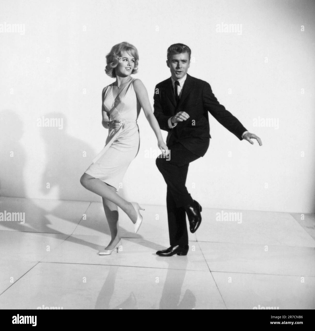 United States:  c. 1961 A photograph of a couple demonstrating how to dance the twist. Stock Photo