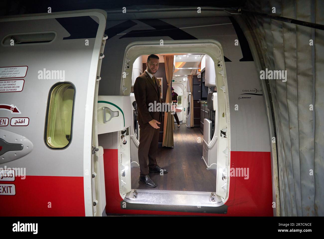 ABU DHABI, UAE - CIRCA JANUARY, 2020: crew member meet passengers in Etihad Airways Boeing 787 Dreamliner at Abu Dhabi International Airport. Stock Photo