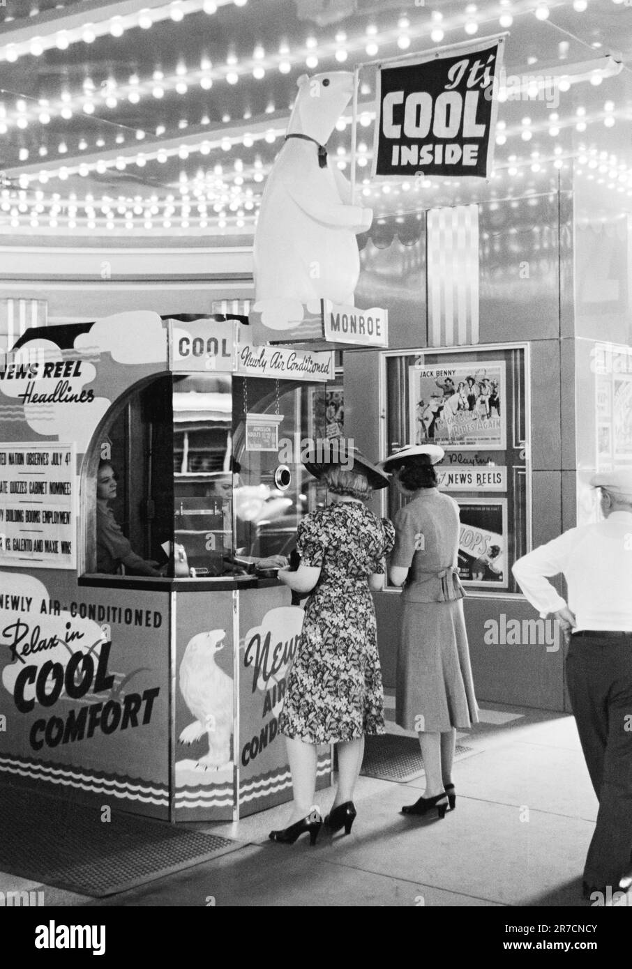 Chicago, Illinois:  July, 1940 Two women buying tickets at a newly air conditioned movie theater on a hot summer day. Stock Photo