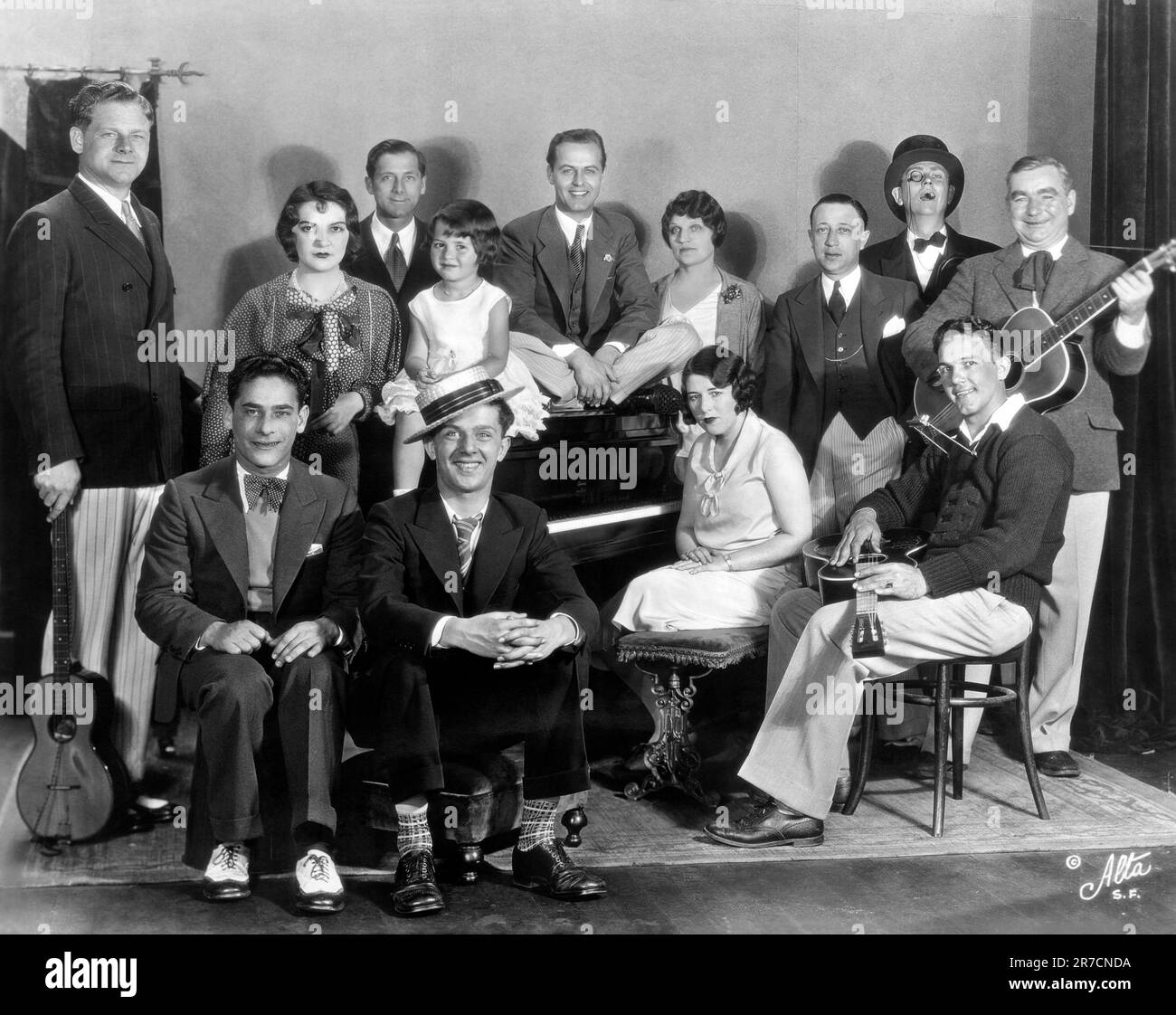 San Francisco, California, 1930. The 'Happy Go Lucky Hour' on KFRC Radio with standing, (L-R): Al Pearce, Edna O'Keefe, Cal Pearce, Jean Clarnioux, Norman Neilsen, Hazel Warner, Abe Bloom, Monroe Upton as Lord Bilgewater and Harry 'Mac' McClintock, and seated, (L-R): Tommy Harris, Charles Carter, Edna Fisher, and Cecil Wright Stock Photo
