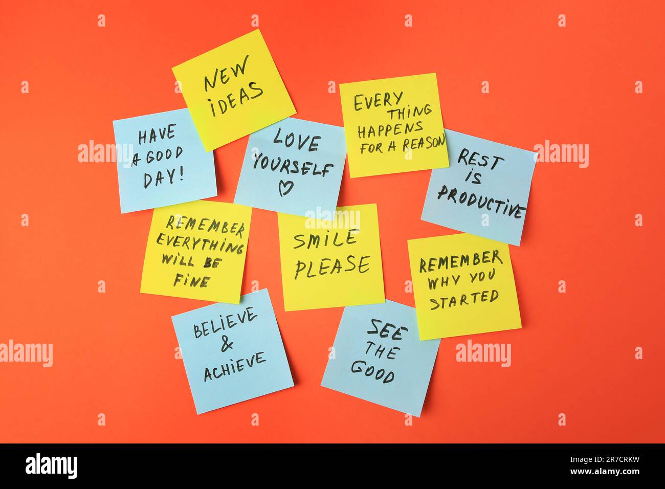 Paper notes with life-affirming phrases on orange background Stock Photo