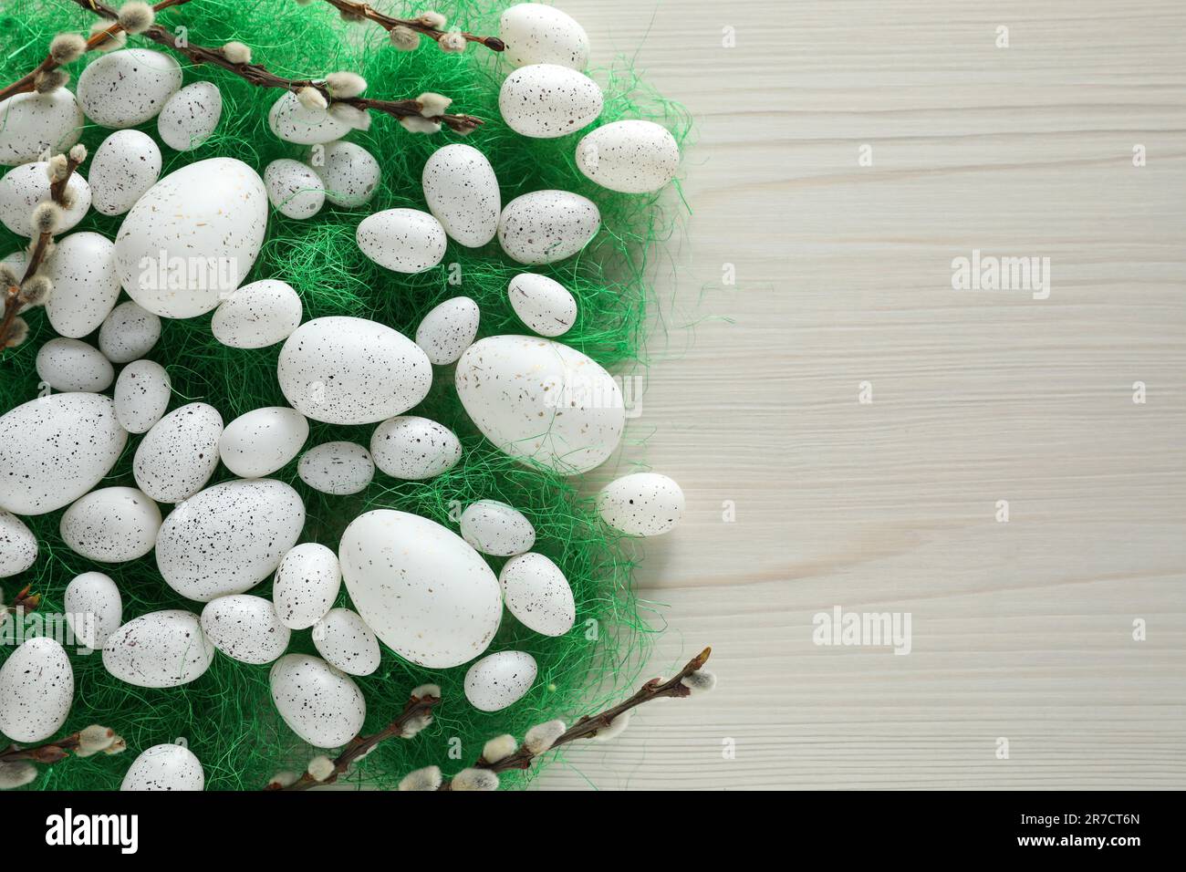 Many beautifully painted Easter eggs and pussy willow branches on white ...
