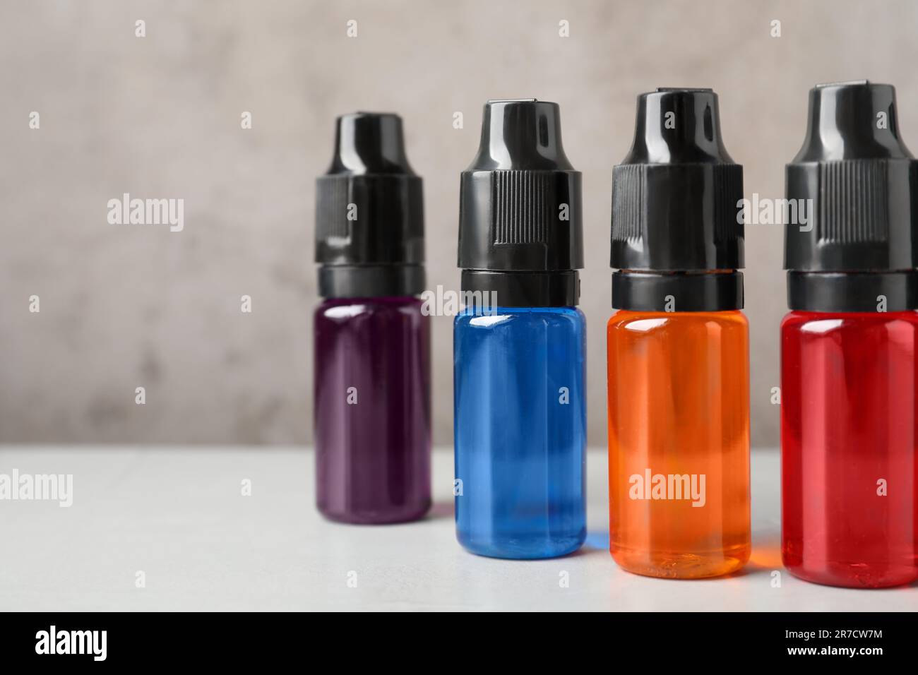 Bottles with different food coloring on white table, closeup Stock Photo