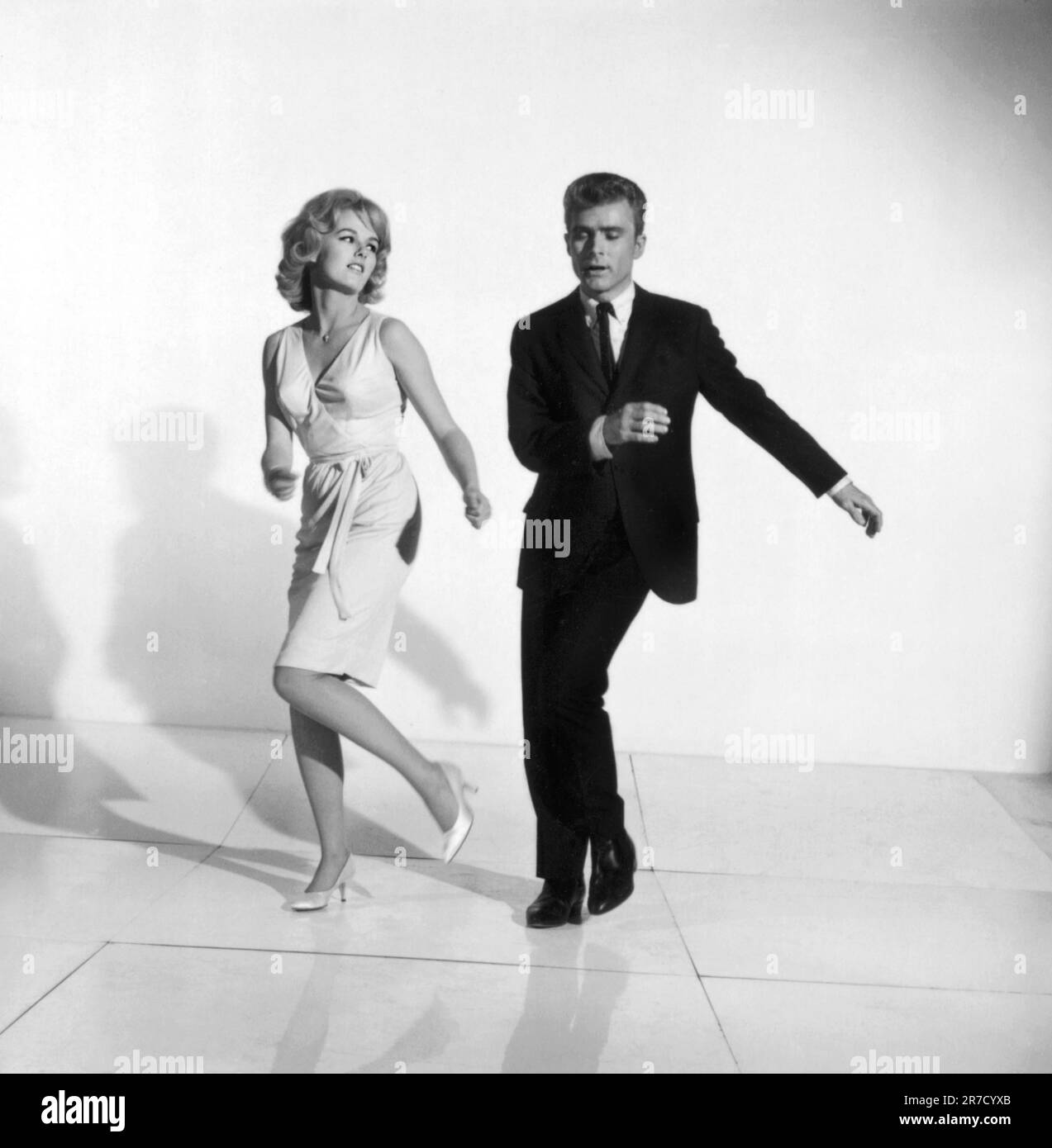 United States:  c. 1961 A photograph of a couple demonstrating how to dance the twist. Stock Photo