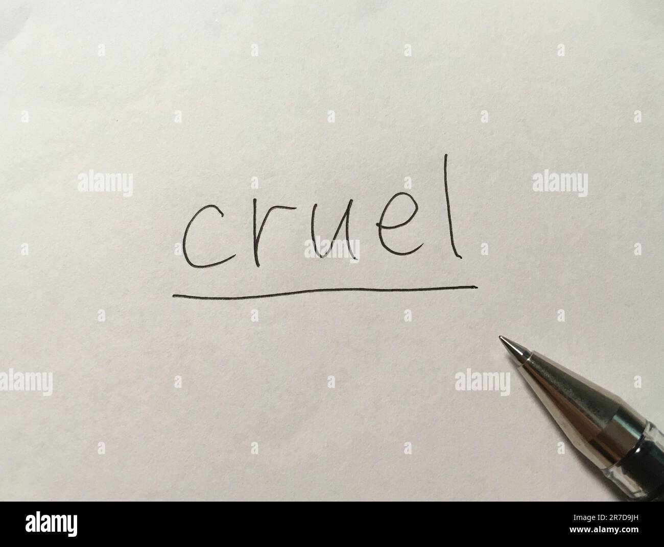 Cruel concept word on paper background Stock Photo