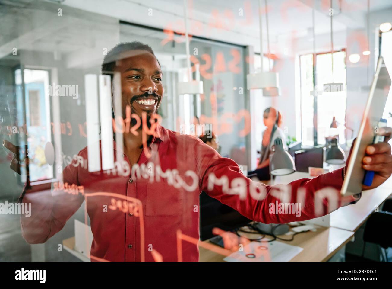 Businessmman working and writing on the glass board in office. Business, research concept Stock Photo