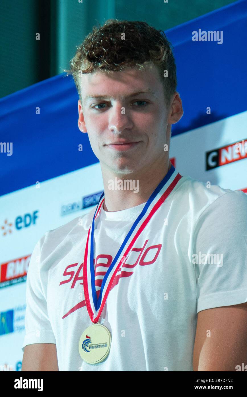 Winner Leon Marchand poses during the Swimming French National