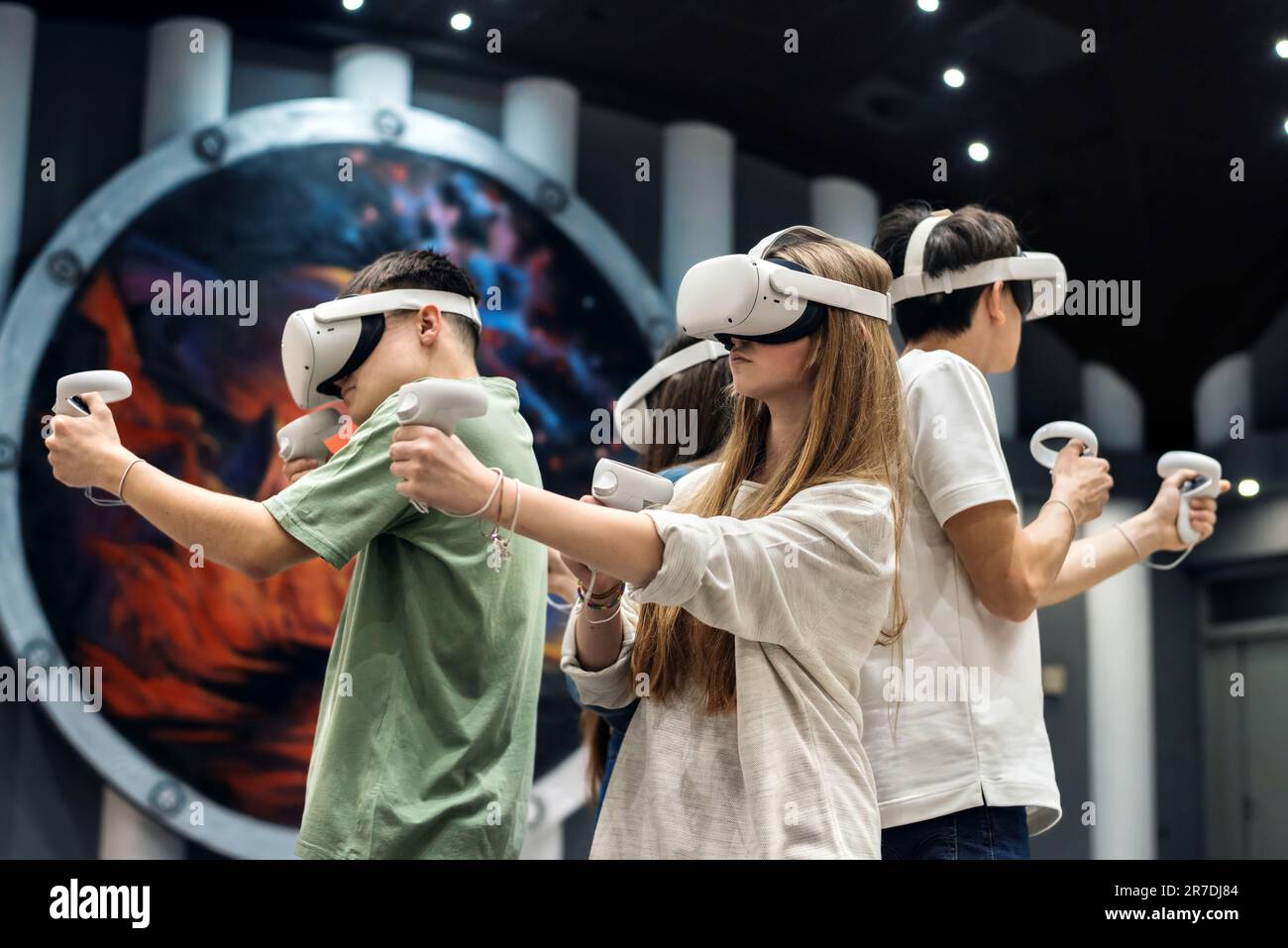 A group of friends interacting with VR equipment. Virtual Reality  Interaction Stock Photo - Alamy