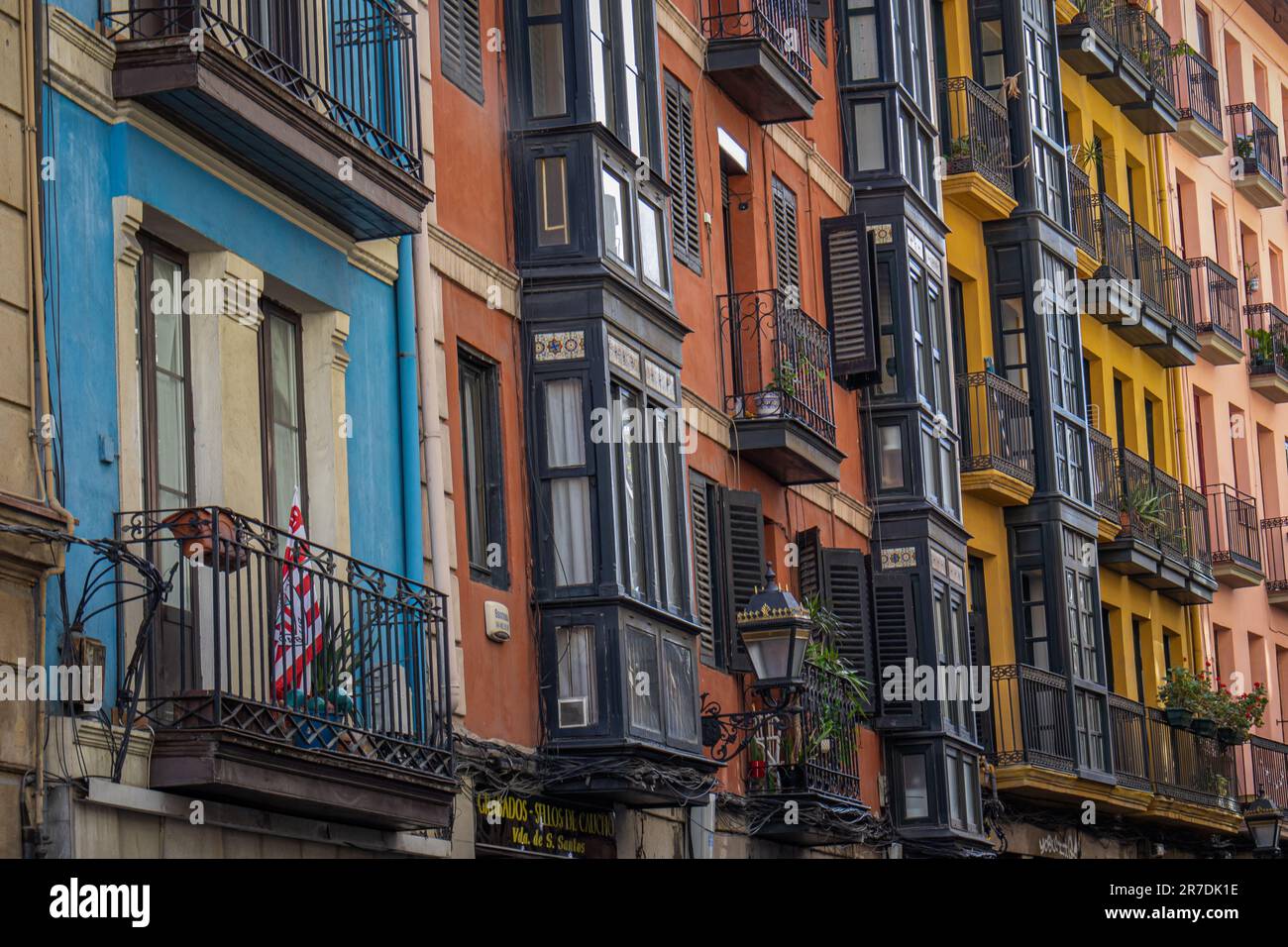 Details of street full of colorful houses in Bilbao, flowers on balconies Stock Photo Alamy