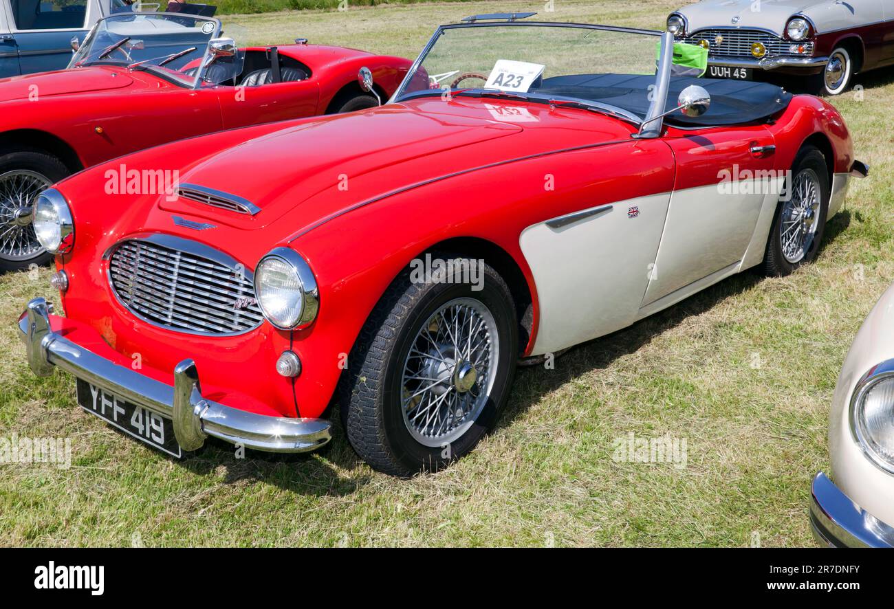 Three-quarters front view of a Red and White,  1958, Austin Healey 100-6, on display at the 2023 Deal Classic Car Show Stock Photo