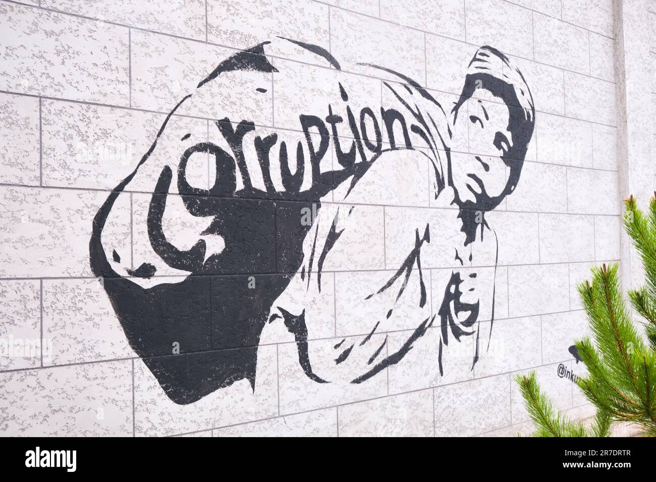 Political spray painted graffiti on a wall, criticizing the corruption in the country. In Tashkent, Uzbekistan. Stock Photo