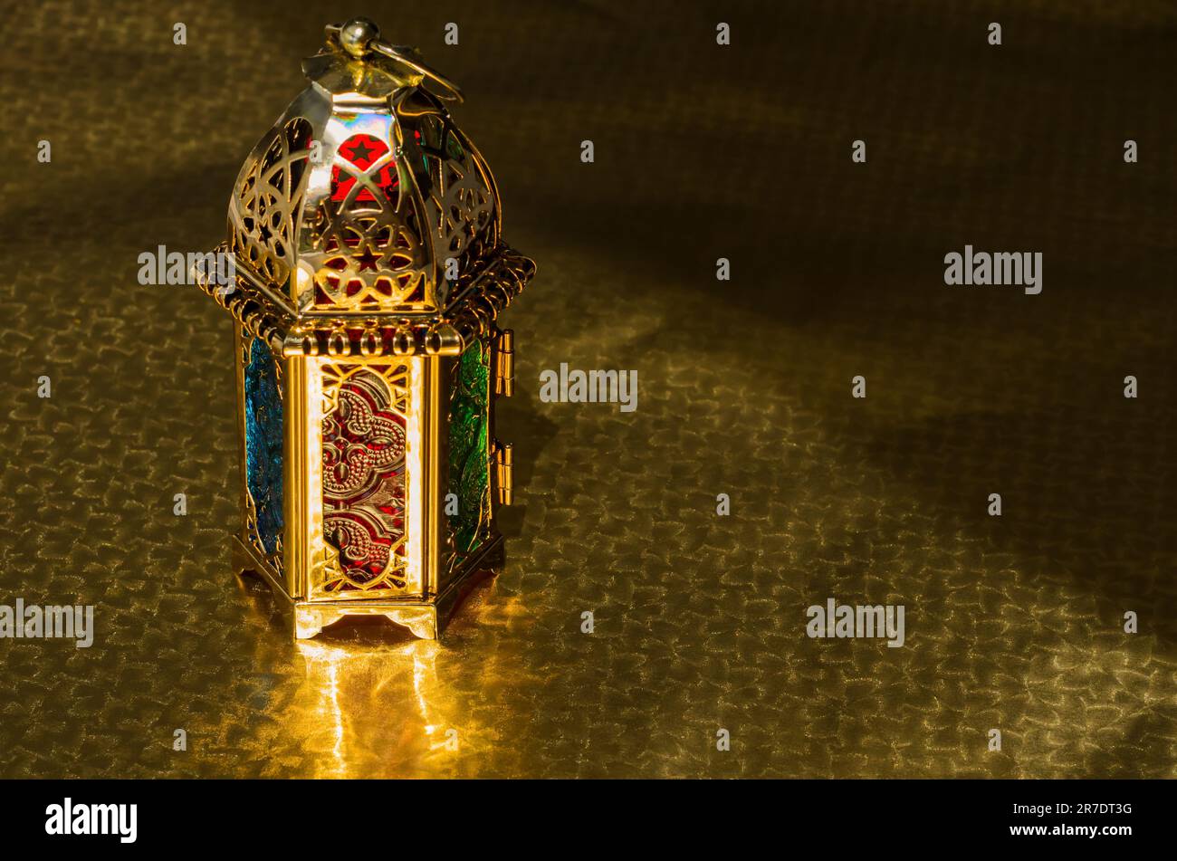 Golden lantern puts on gold color background for Ramadan Kareem and Islamic new year concept. Stock Photo