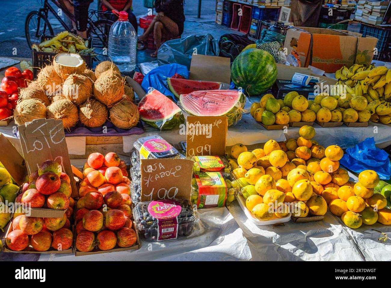 Rio de Janeiro, Brazil - June 8, 2023: Fresh fruits and nuts are displayed for sale. The assortment includes apples, bananas, coconuts, and watermelon Stock Photo