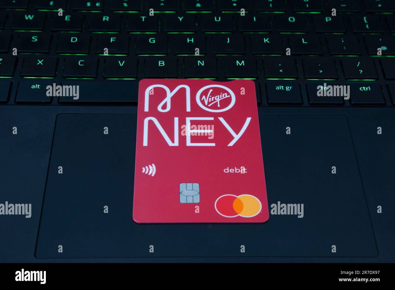 Debit Card with Money Logo sitting on a laptop Stock Photo