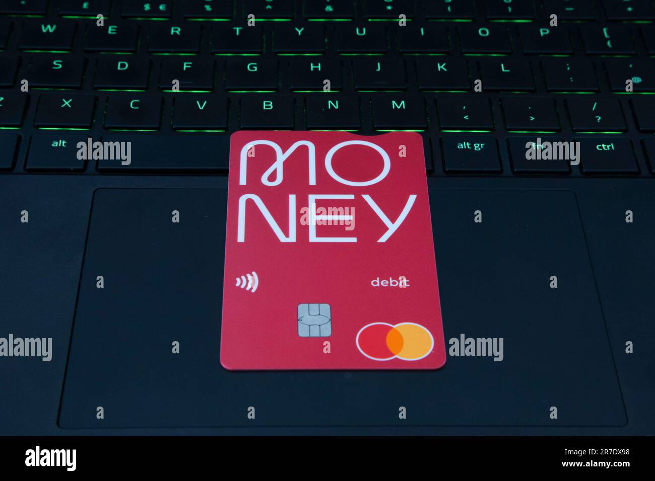 Debit Card with Money Logo sitting on a laptop Stock Photo