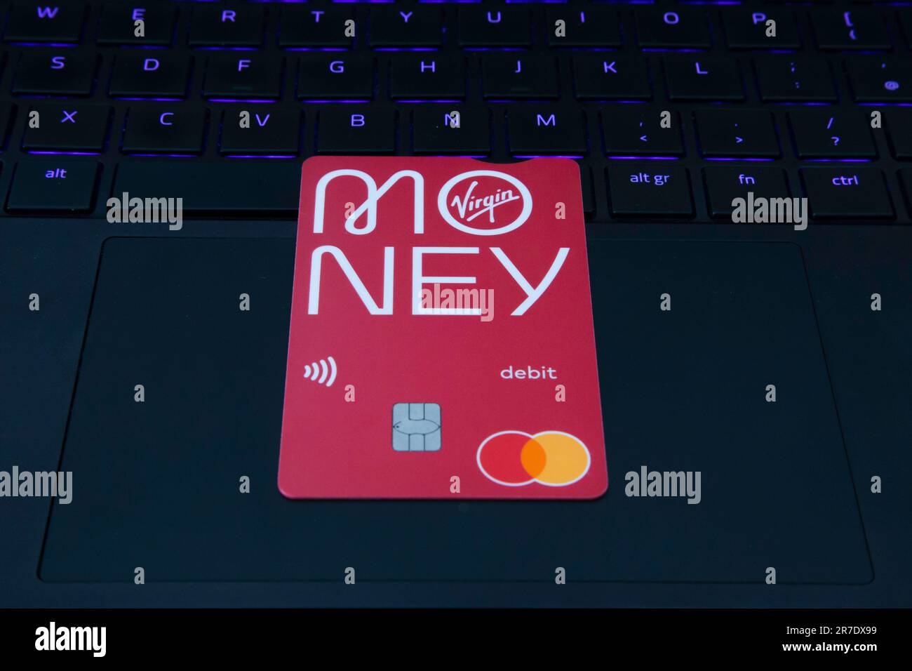 Debit Card with Money Logo sitting on a laptop Stock Photo