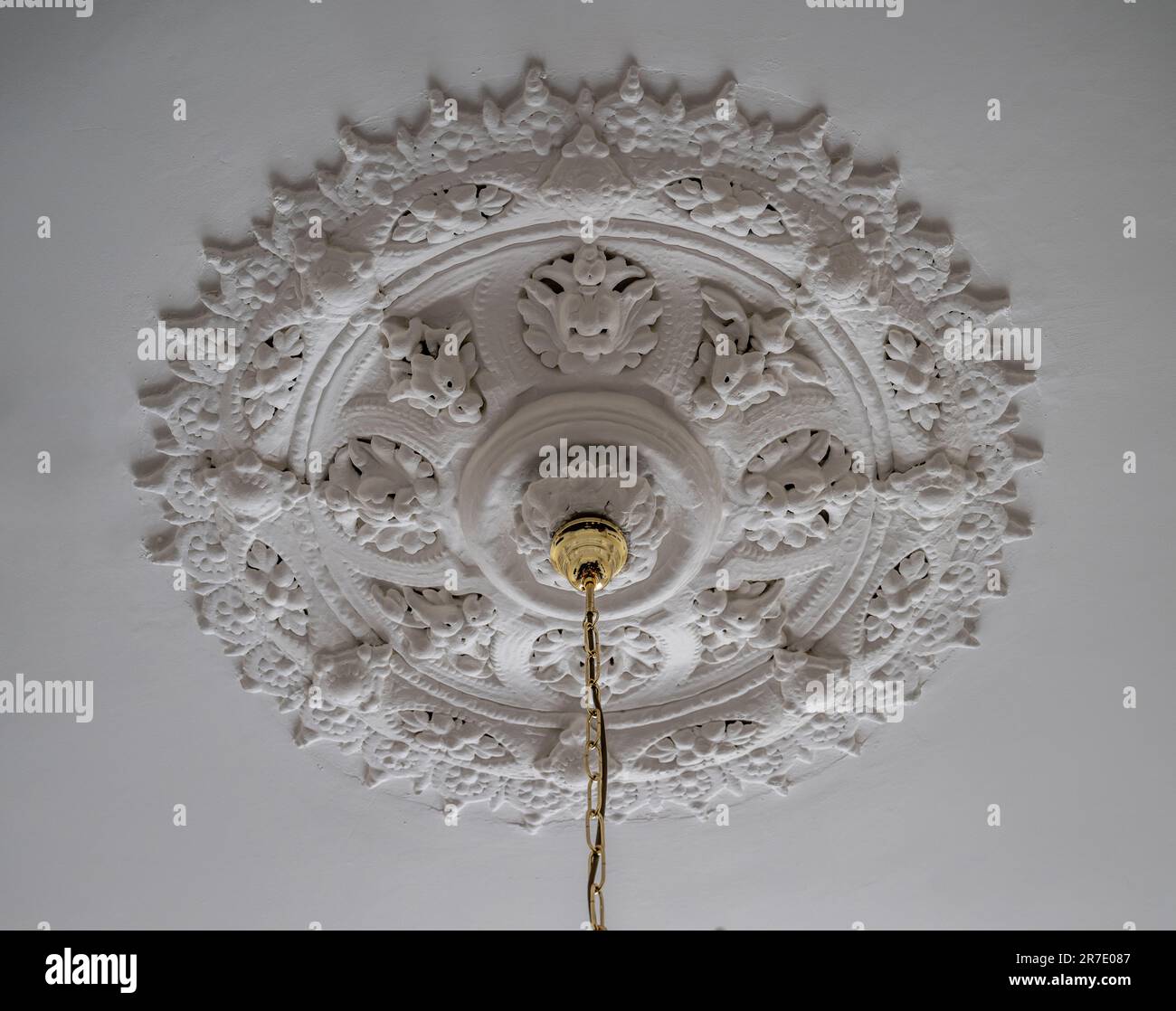 An ornate plaster ceiling rose on a white ceiling in a UK property Stock Photo