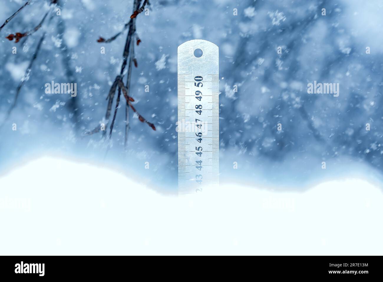 Yardstick measuring the depth of snow.Heavy snowfall in the garden is