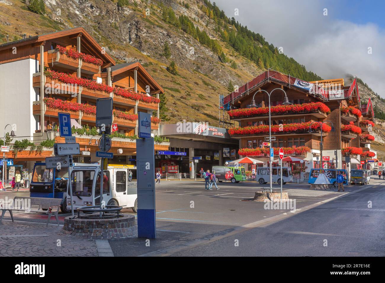 Zermatt, Switzerland - October 7, 2019: Town center street and railway station square view in famous swiss ski resort, colorful traditional houses Stock Photo