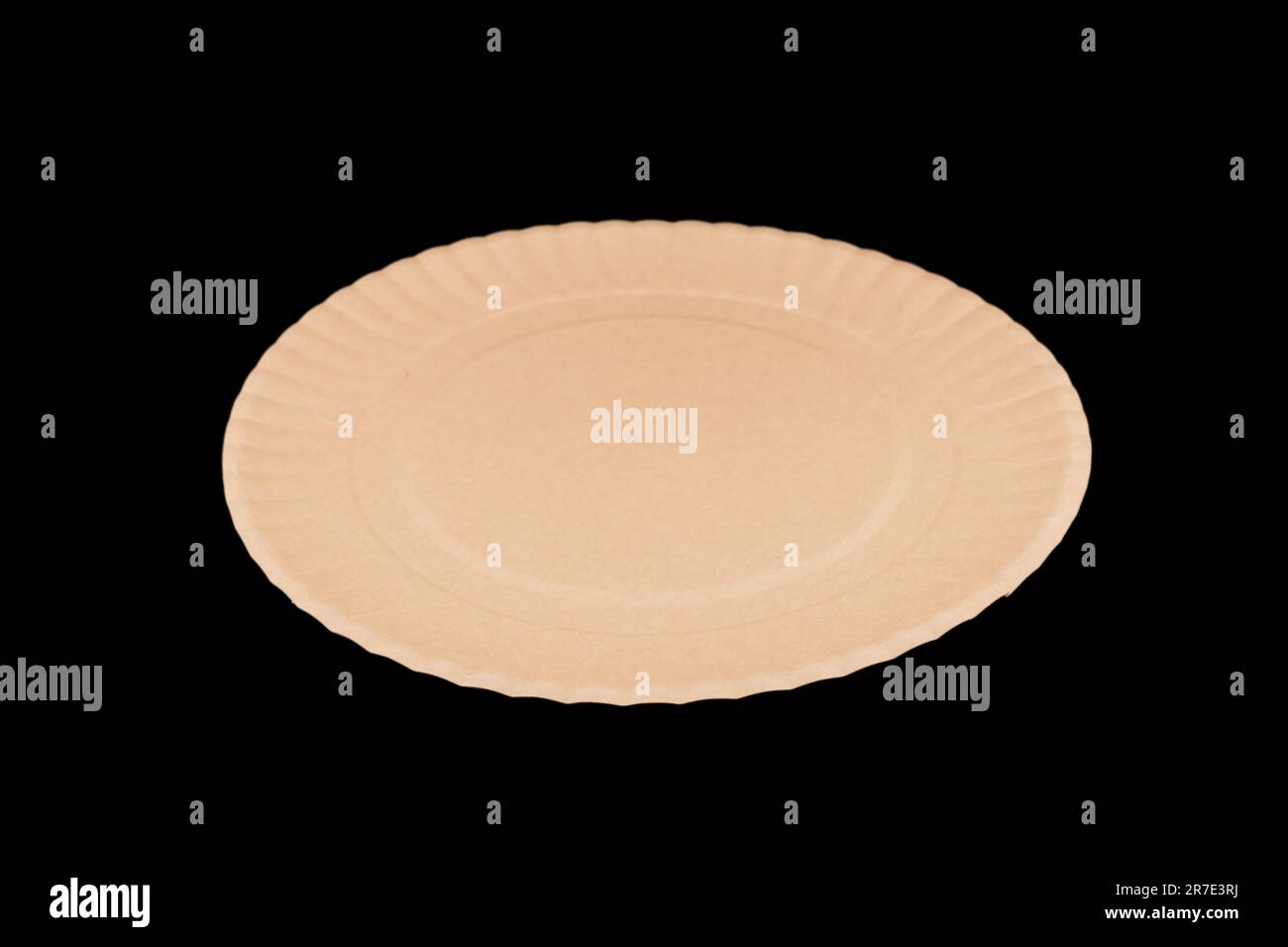 Side view yellow empty disposable paper fast food plate isolated on black background. Stock Photo