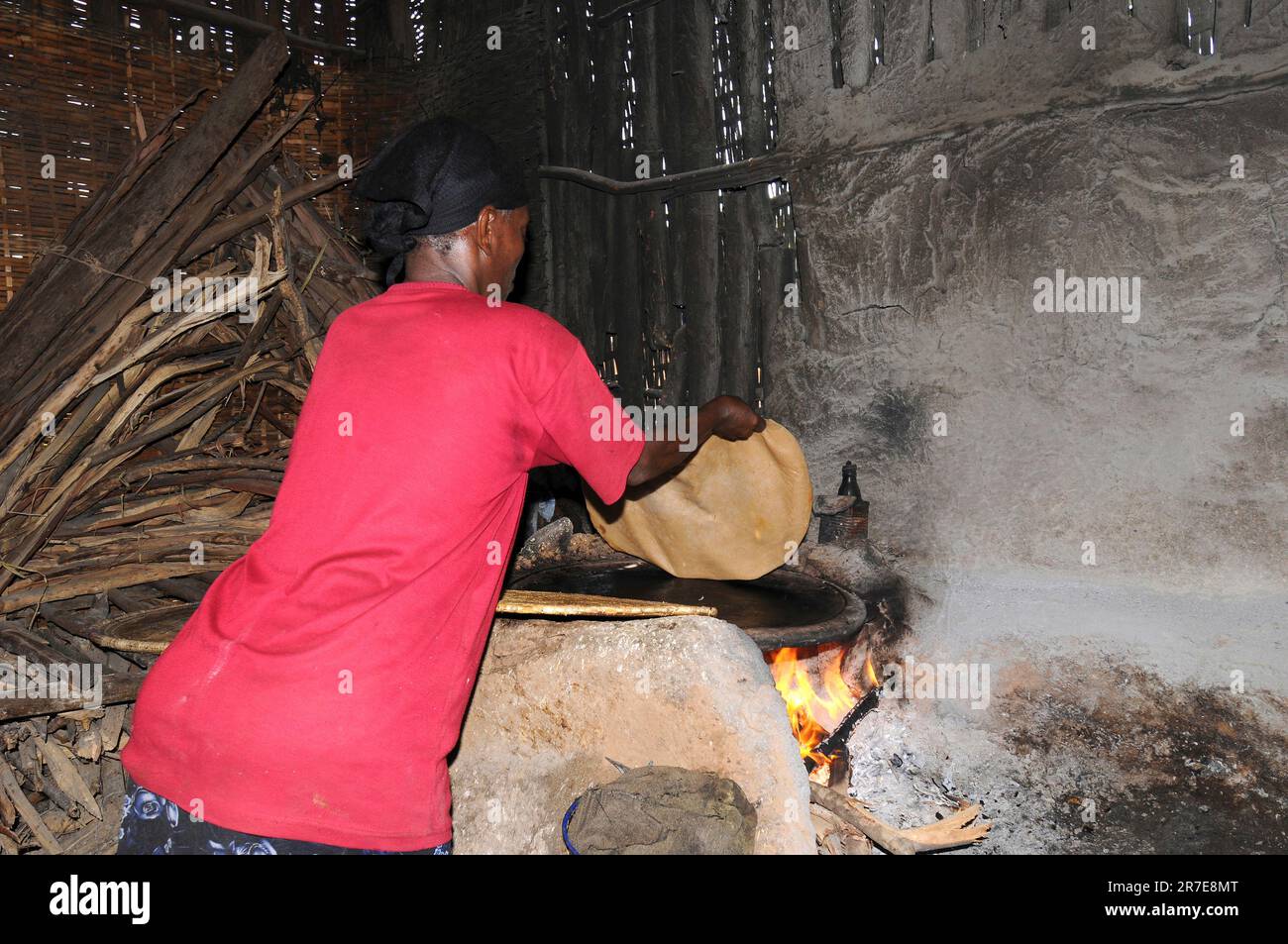 Ethiopian woman cooking injera. Injera is traditional food made with