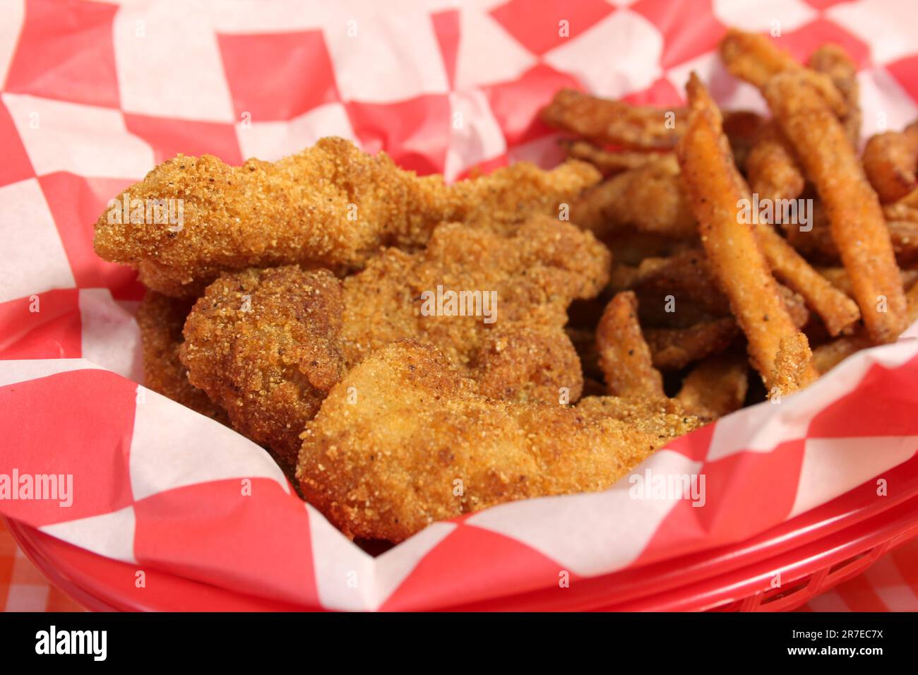 Fried Catfish Basket With French Fries in Rustic Cafe on Checkered