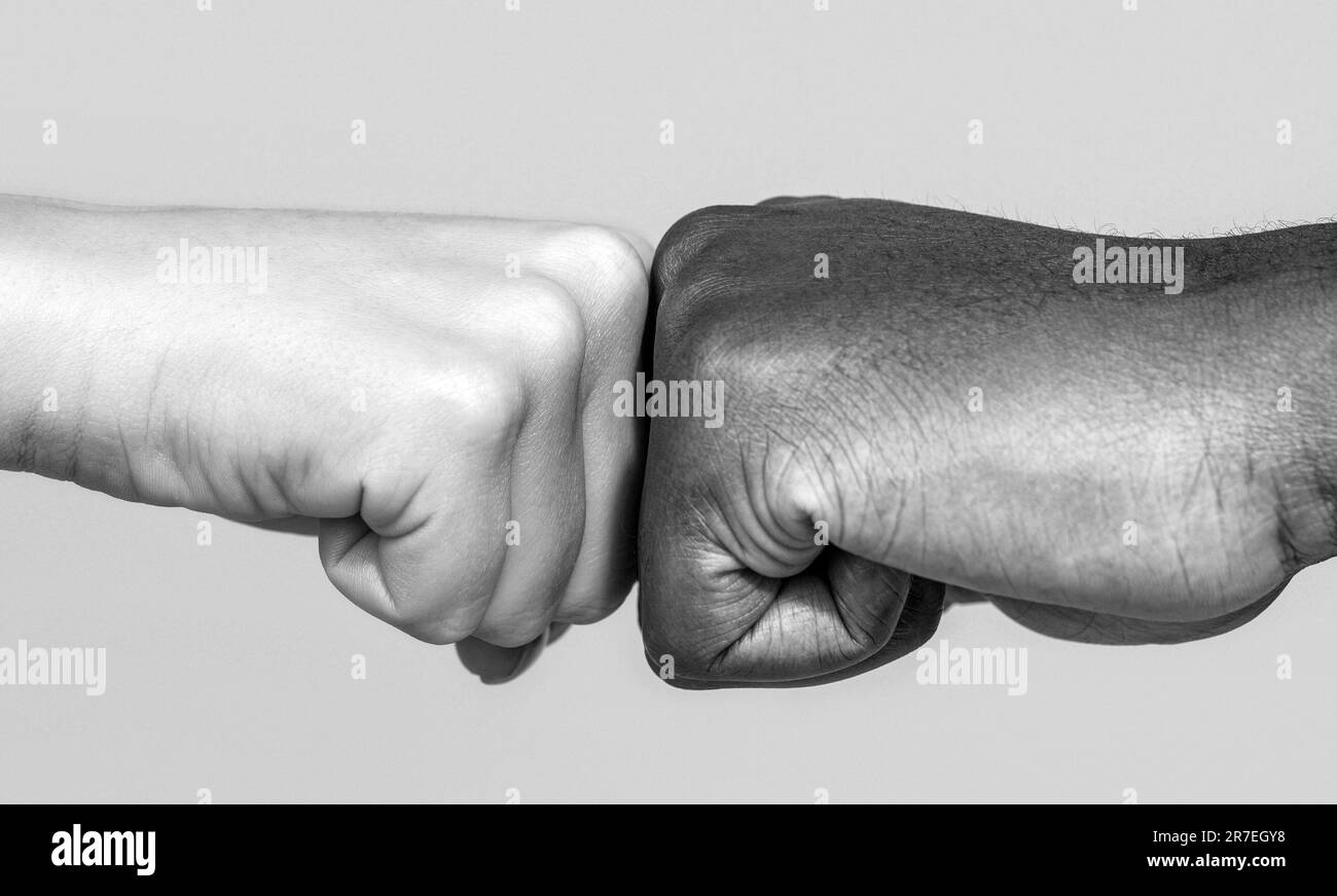 Black african american race male and woman hands giving a fist bump. Black and white Stock Photo