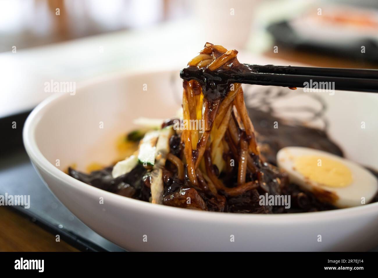 Delicious Jajangmyeon, jjajangmyeon, fried sauce noodle, Korean-style Chinese noodle dish topped with thick black bean paste sauce in south korea. Stock Photo