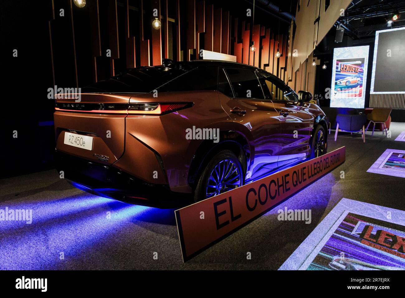 Lexus Rz Poster A comic with the new Lexus RZ model in front of the car model during ...