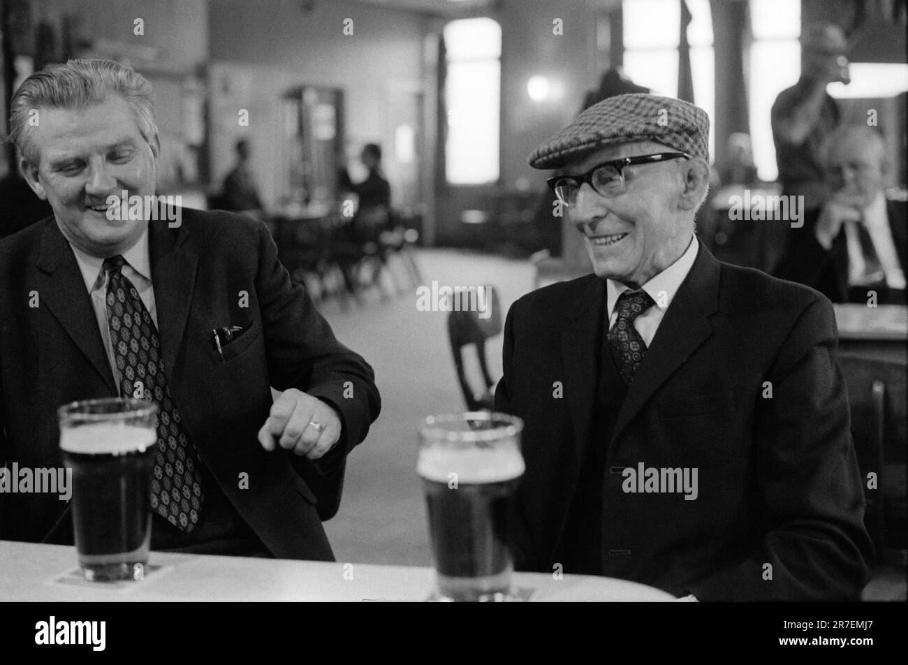 Working Mens Club UK 1970s. Sunday morning drinking, two men wearing their 'Sunday best' clothes. Getting dressed up, in a clean ironed shirt and tie,  and wearing a  sports jacket was normal at the time. Pints of beer at the Byker and St Peters Working Men's Club, Newcastle upon Tyne, Tyne and Wear,  northern England 1973. HOMER SYKES  . Stock Photo