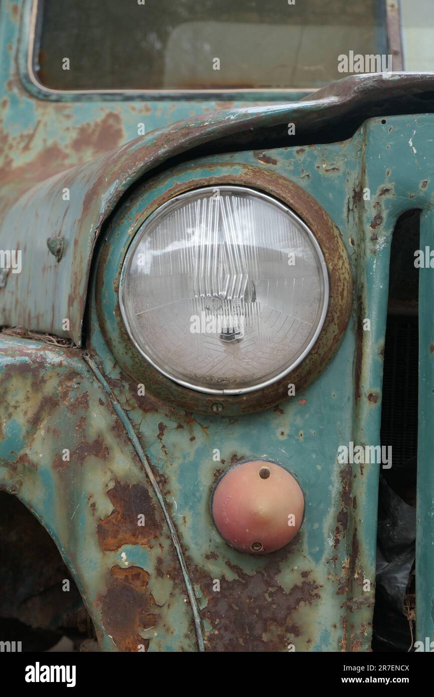 Headlight of a retro rusty small truck Stock Photo