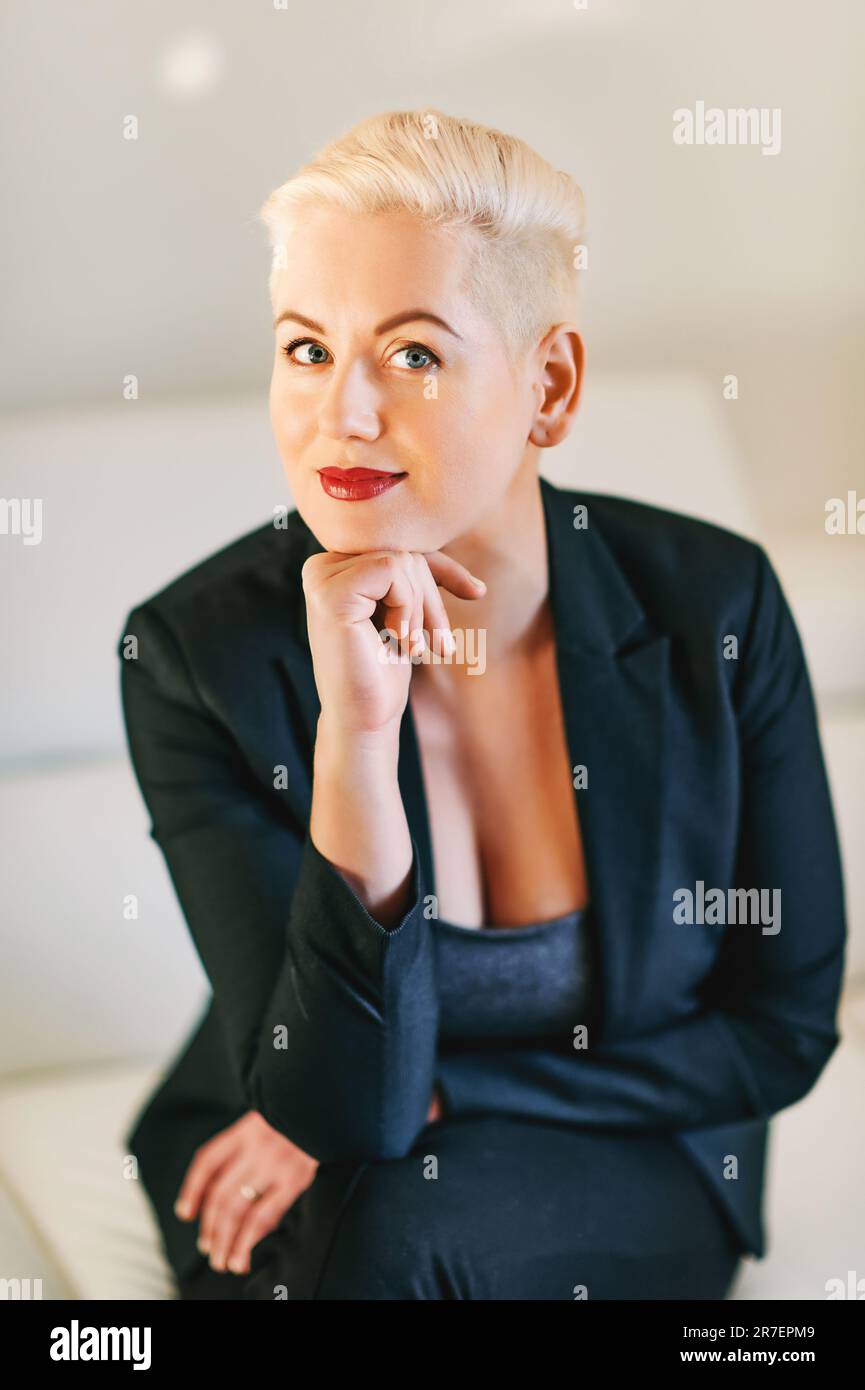 Business portrait of mature woman with short haircut, wearing jacket Stock Photo
