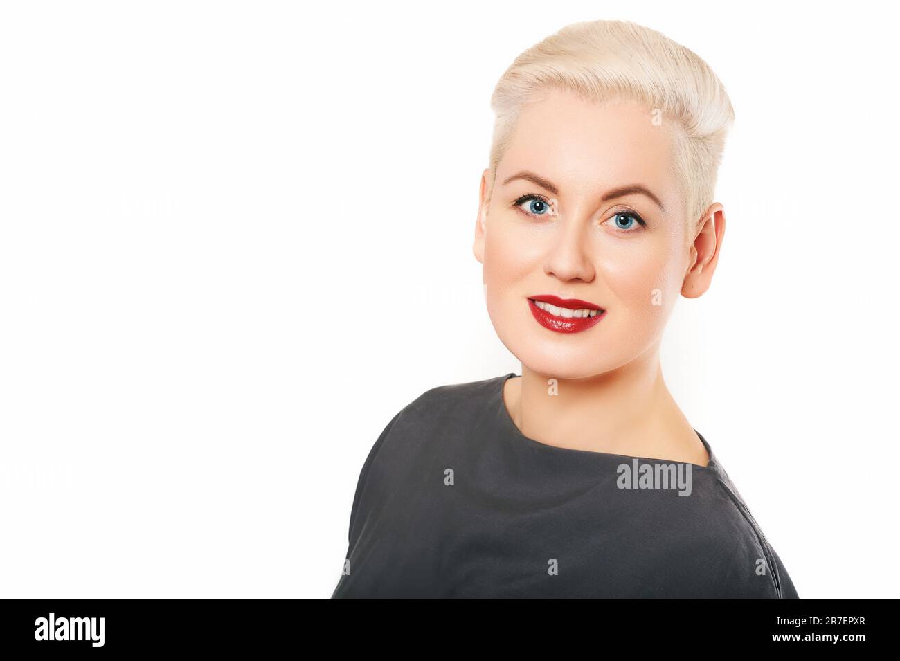 Studio close up portrait of beautiful mature woman on white background, short haircut Stock Photo