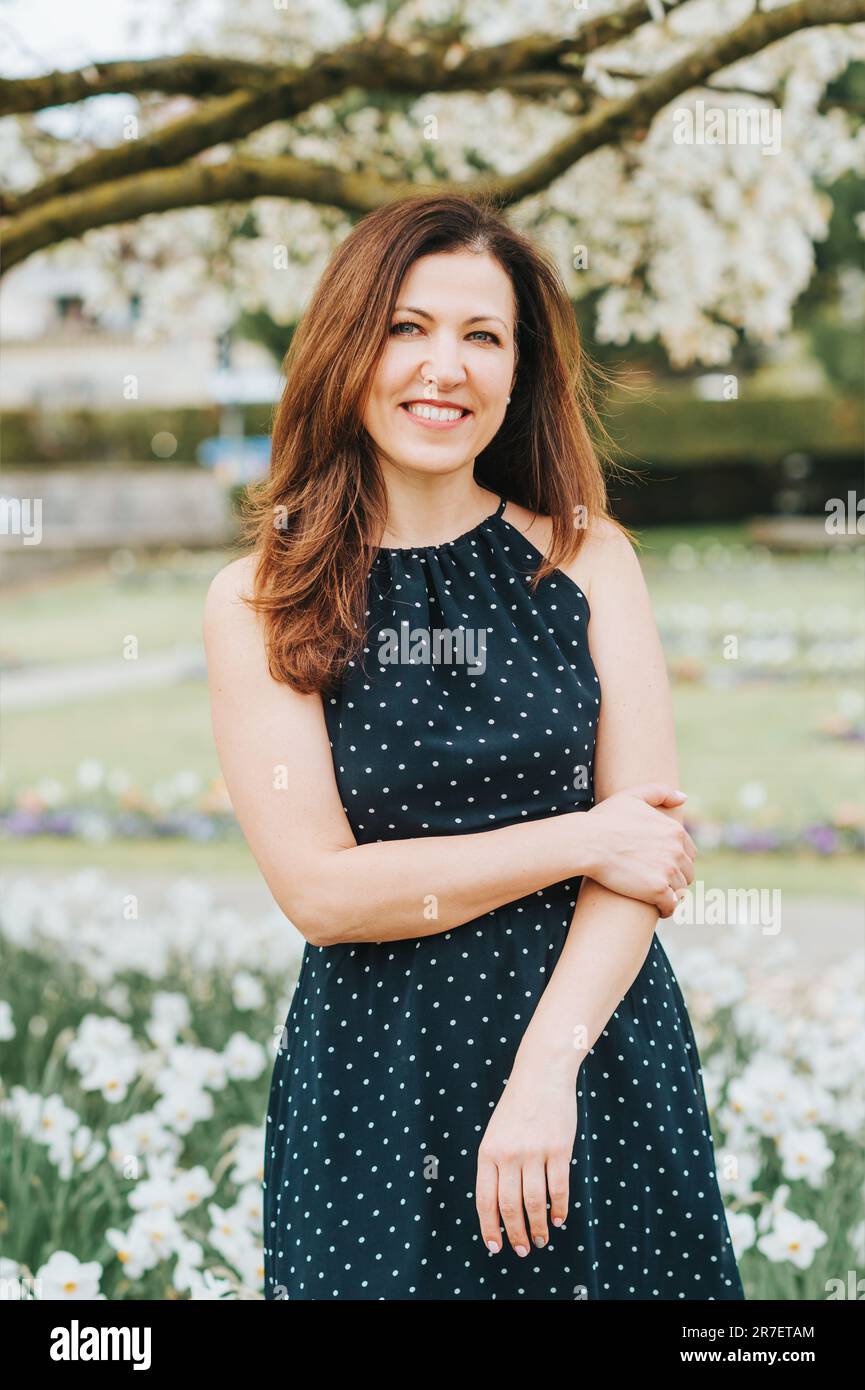 Outdoor portrait of beautiful woman posing in spring park Stock Photo ...