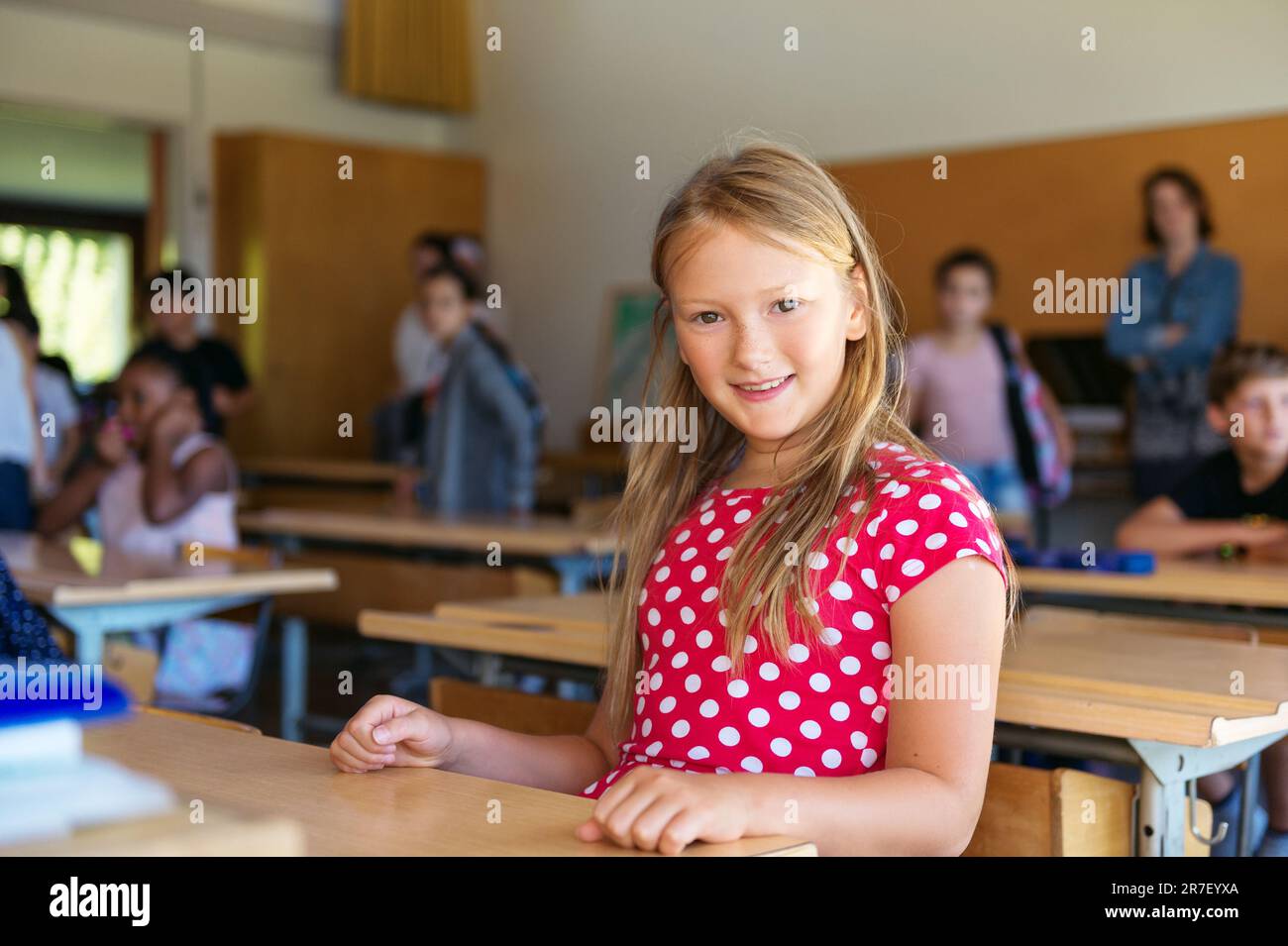Indoor portrait of a cute little girl in a classroom Stock Photo - Alamy
