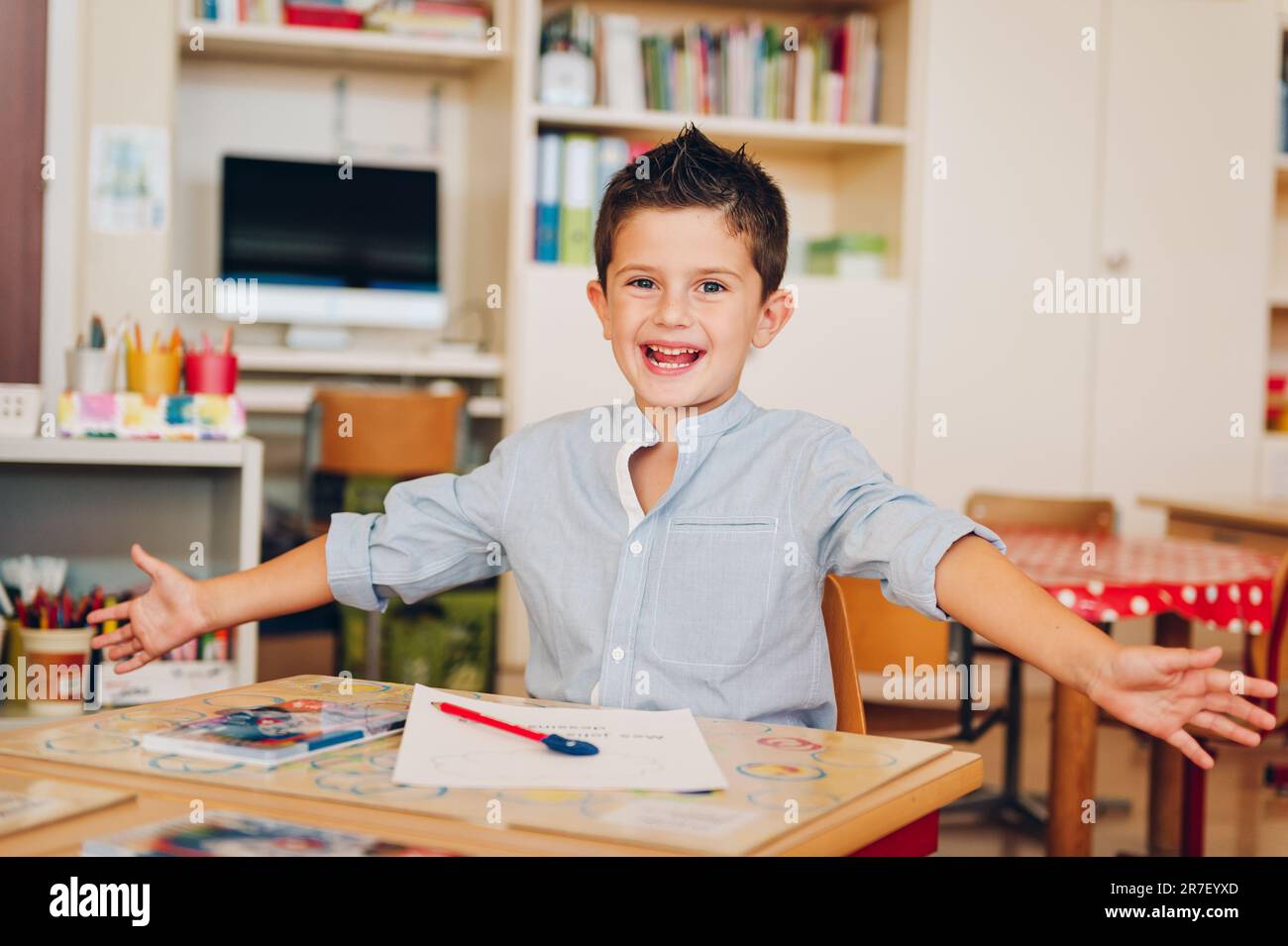 Indoor portrait of a cute little boy in a classroom Stock Photo - Alamy