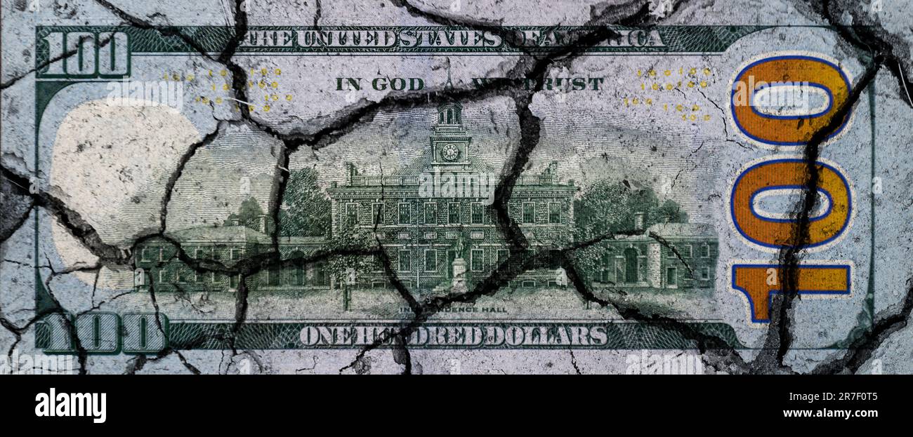 Hundred dollar bill with cracks. US dollar banknote broken into pieces. US financial crisis