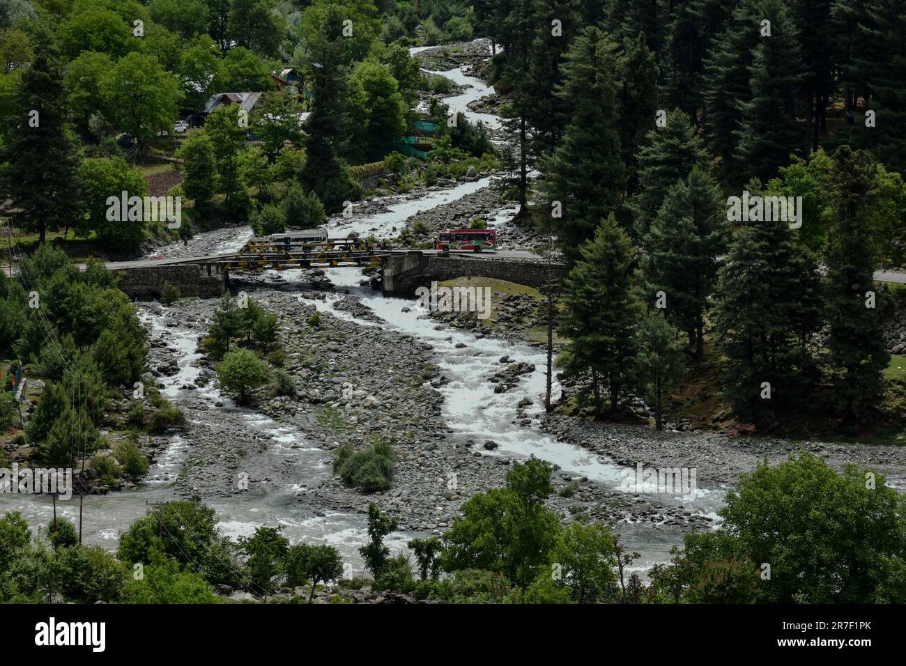 Pahalgam, India. 15th June, 2023. A tourist bus moves along the road in ...