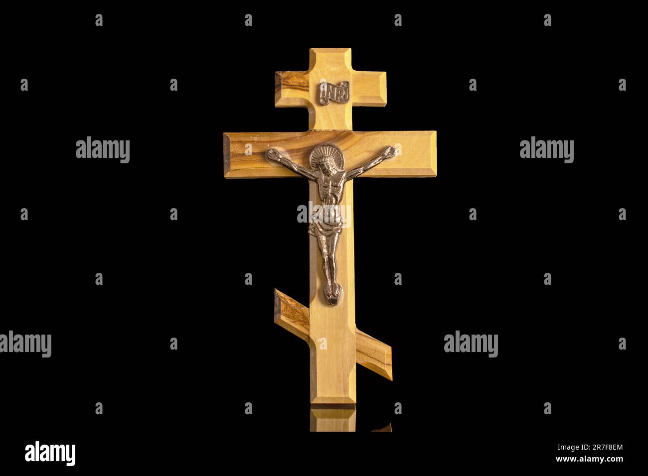 One wooden church cross, macro, isolated on white background. Stock Photo