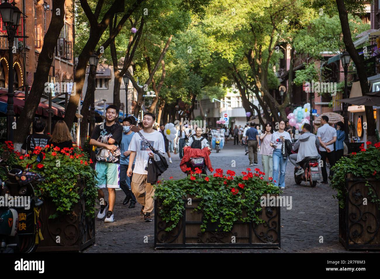 (230615) -- WUHAN, June 15, 2023 (Xinhua) -- Tourists visit Lihuangpi Street of Hankou historical area in Wuhan, central China's Hubei Province, June 6, 2023. Covering an area of 6.02 square kilometers, the Hankou historical area in the heart of Wuhan City's old town, boasts an abundance of historical and cultural heritages.    In recent years, Wuhan City has undertaken many urban renewal projects to revitalize this area's aging buildings. The historical area has seen significant changes through those efforts. (Xinhua/Wu Zhizun) Stock Photo