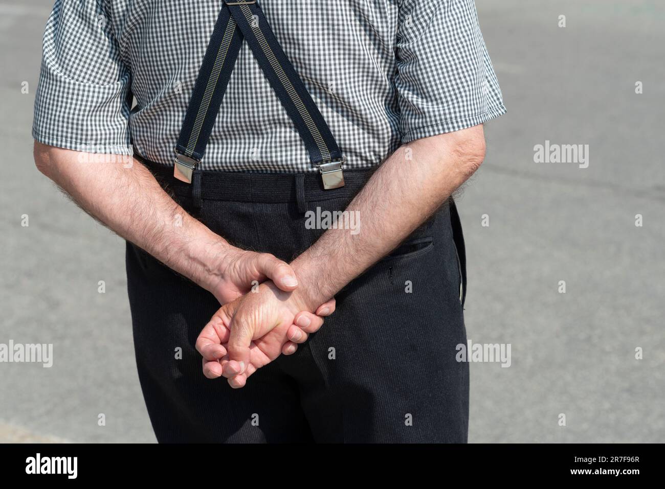 Senior Man  Standing with their Hands Behind their Back Stock Photo
