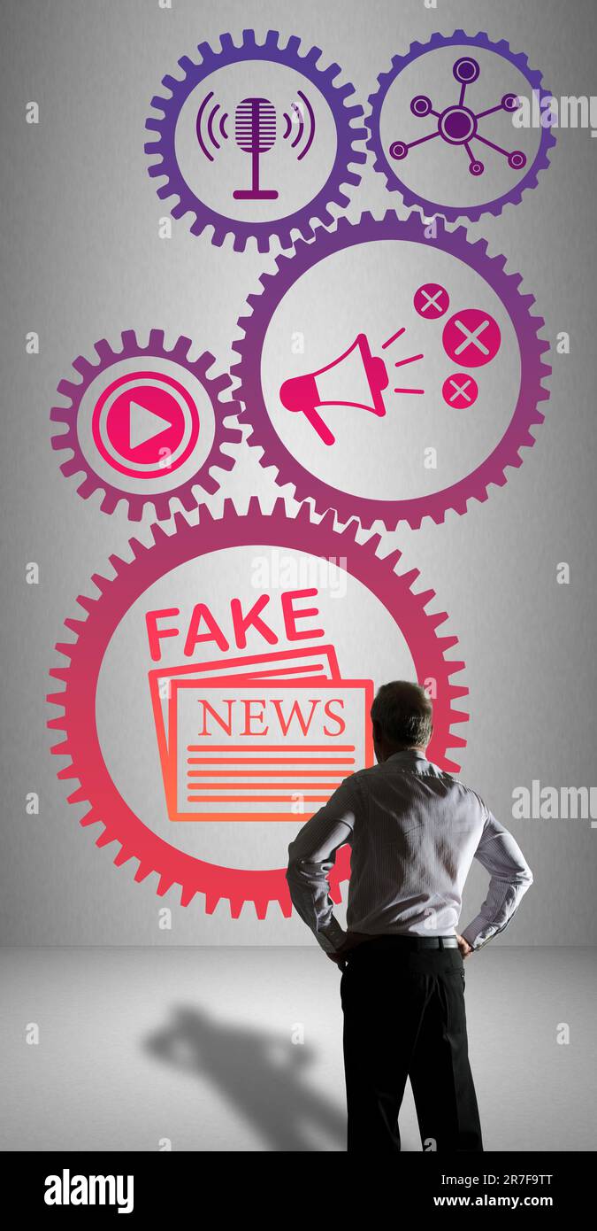 Businessman watching a fake news concept drawn on a wall Stock Photo