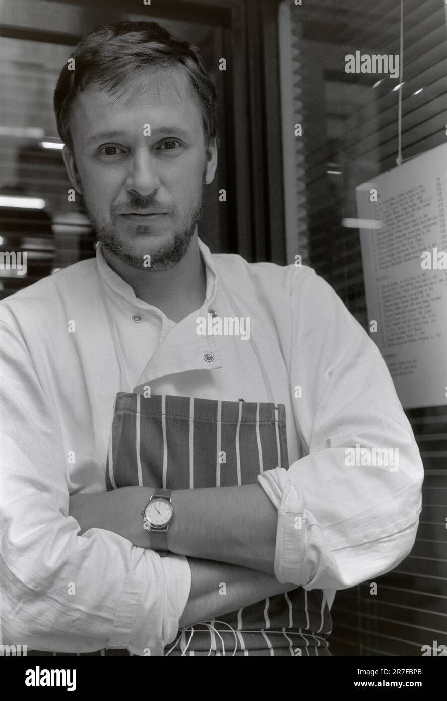 Alastair Little, chef, standing outside his restaurant in Frith Street, Soho, London, UK June 1987 Stock Photo